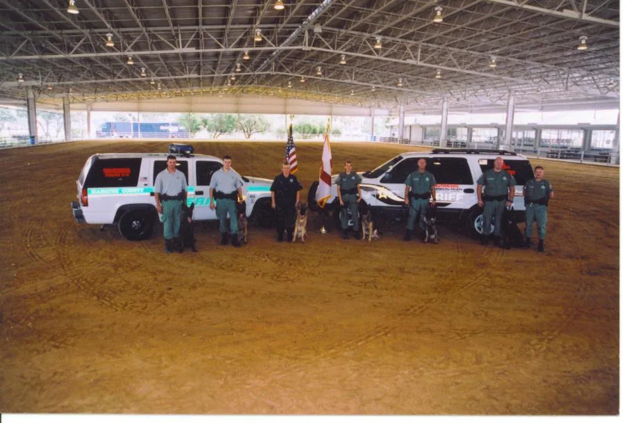 K-9 handlers and dogs with Hillsborough County Sheriff vehicles
